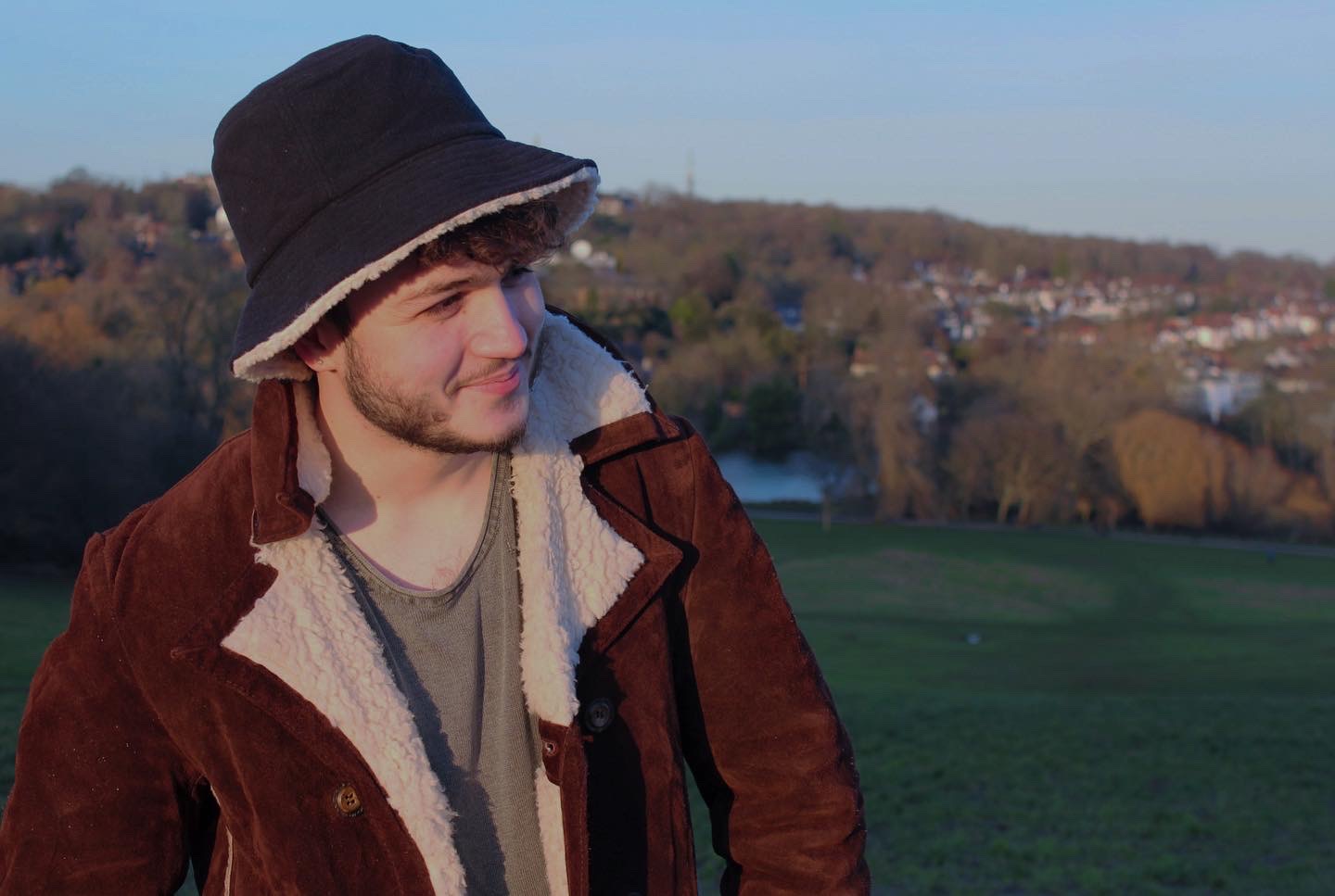 Exterior mid-shot of Alex Ridao, GSFF marketing intern, wearing a sheepskin coat and hat.